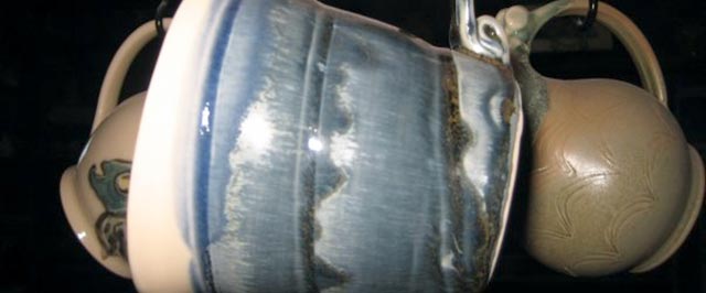 Blue glazed mugs and cream pottery