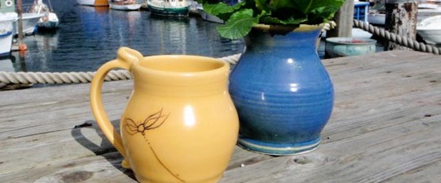 Yellow dragonfly pitcher and blue vase on the marina dock